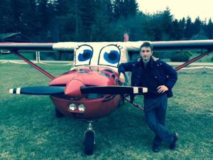 A small red airplane with eyes painted on the cover